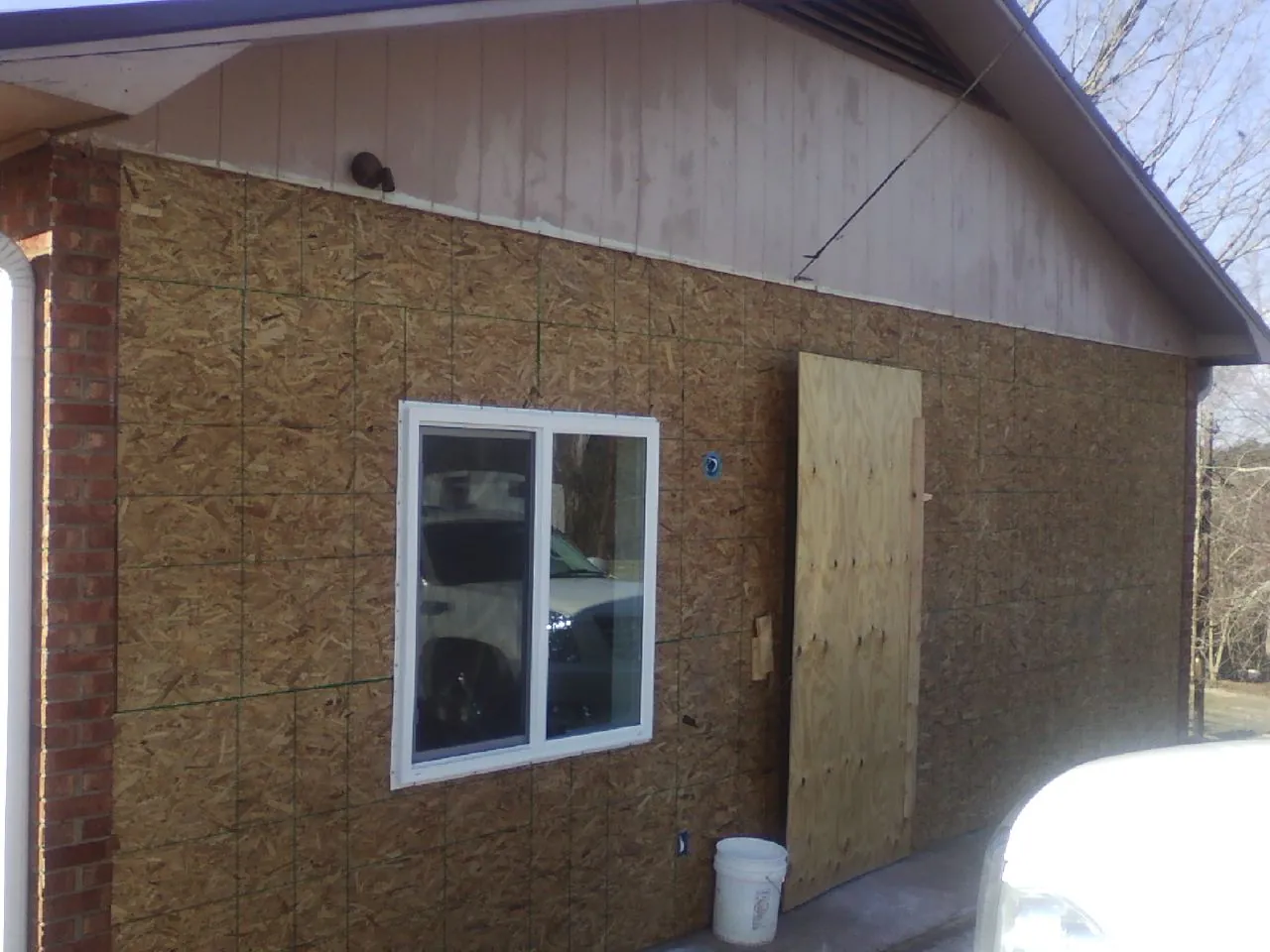 OSB sheathing on a garage addition wall before siding in Bainbridge Island